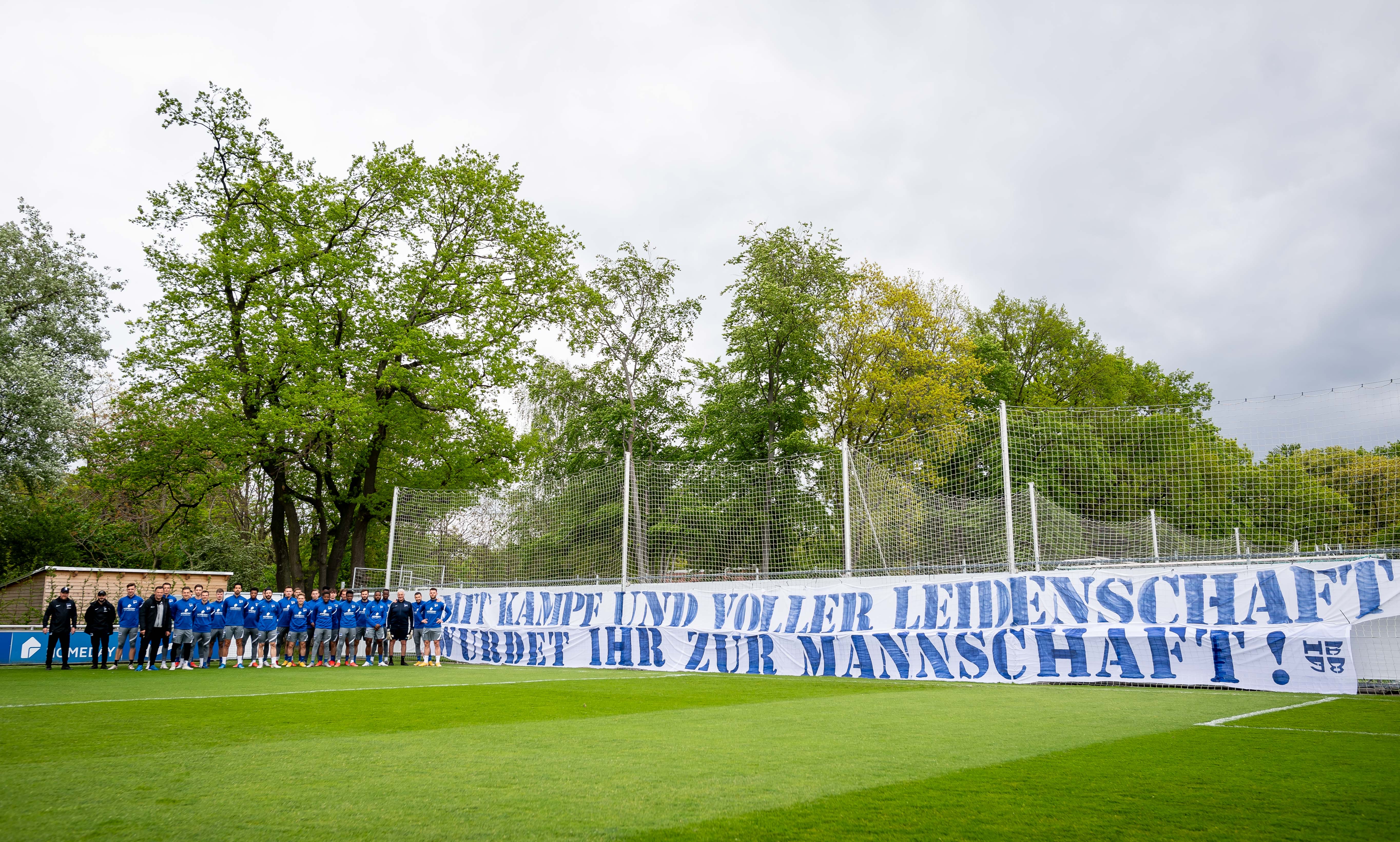 The players in front of the fans' banner