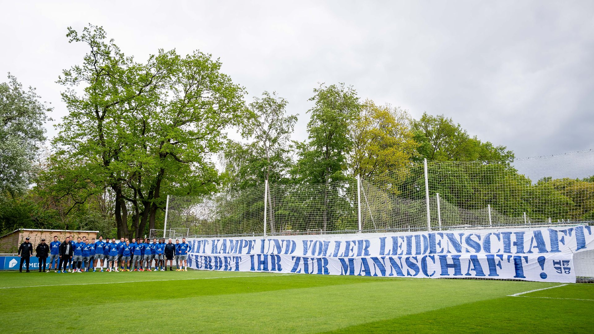 The players in front of the fans' banner