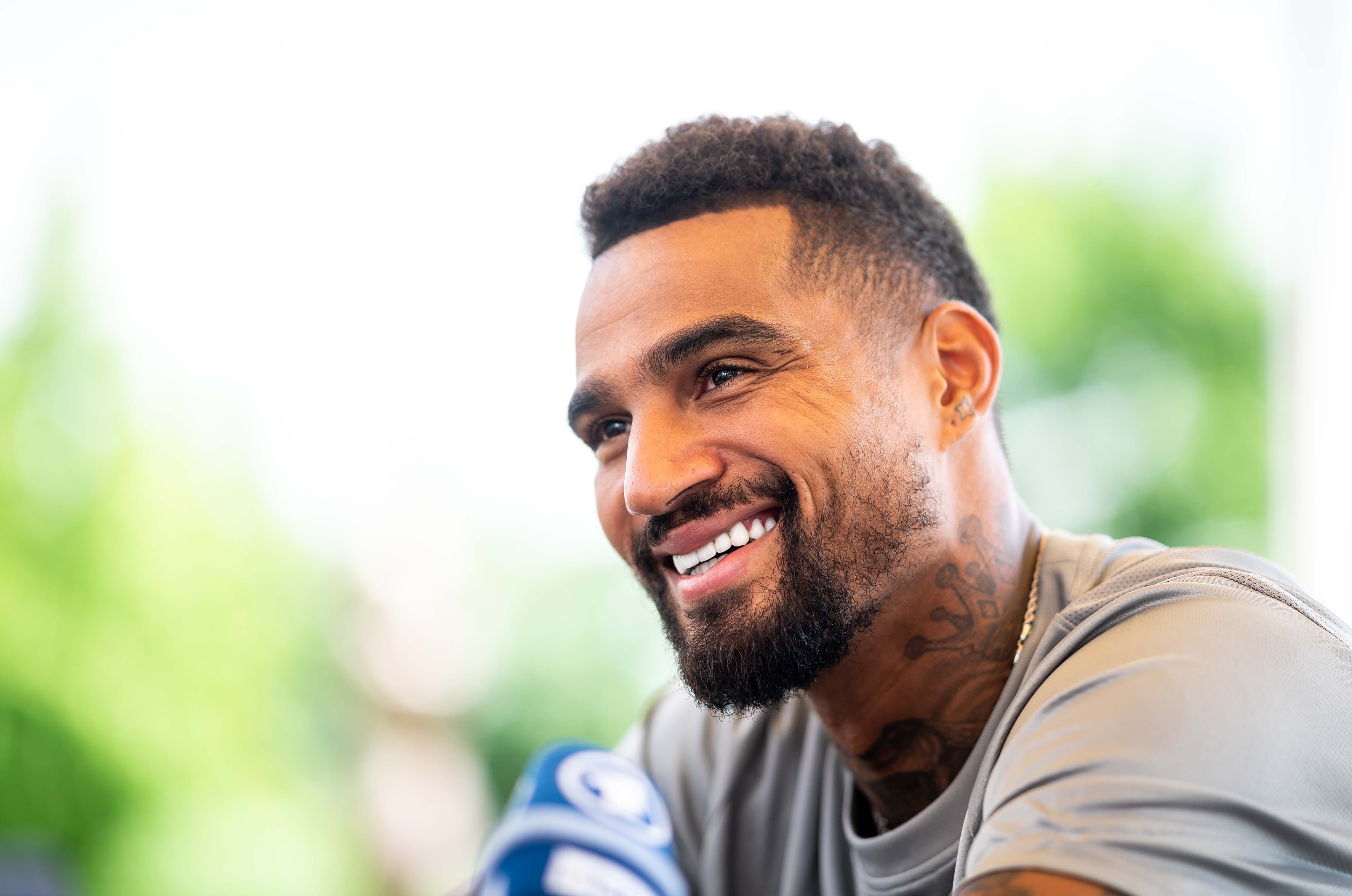 Prince Boateng smiling during a press conference.
