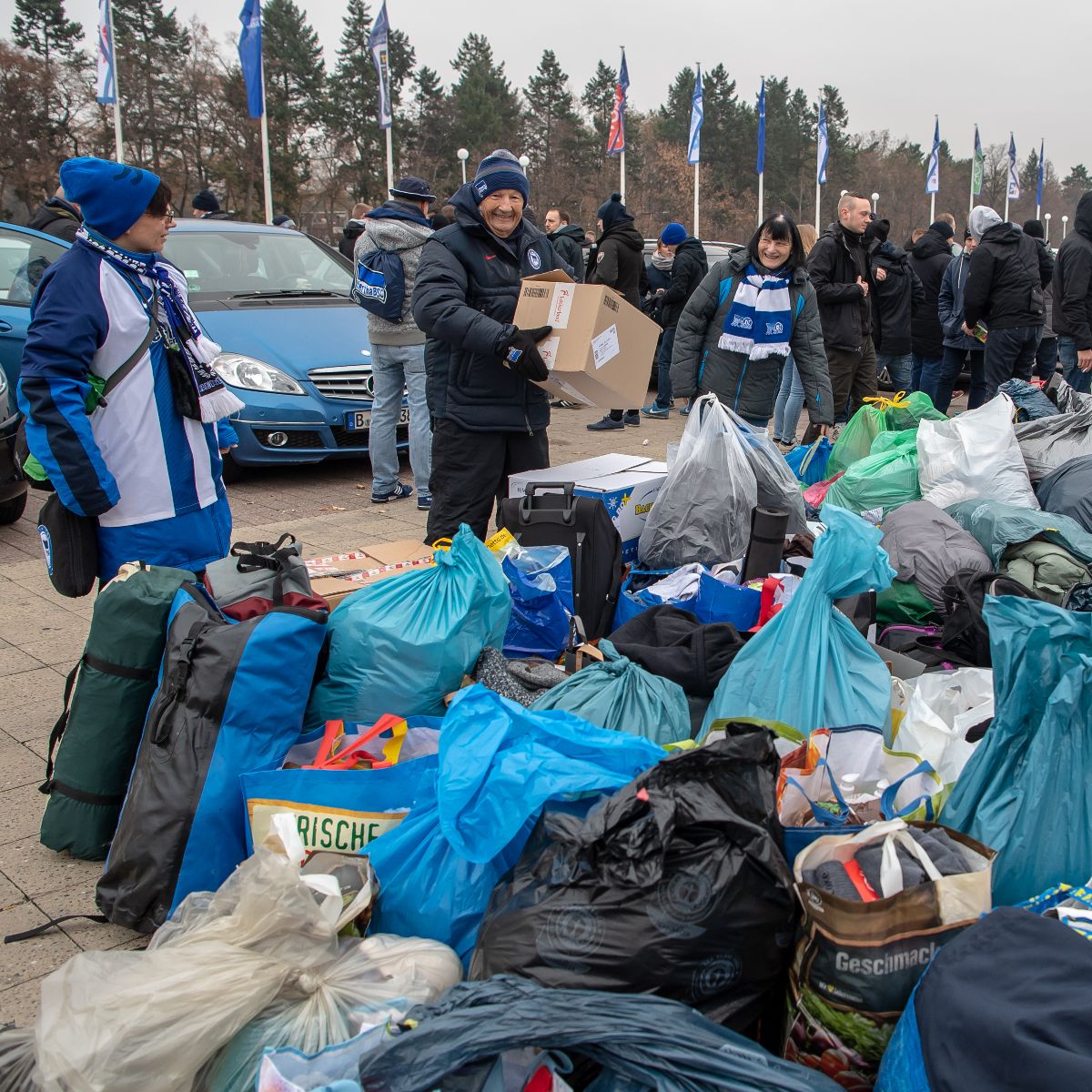 Helfende sammeln vor dem Olympiastadion Spenden.