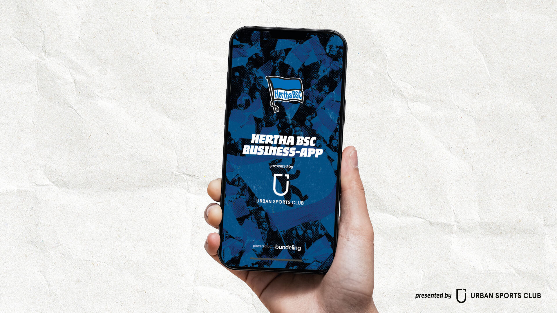 Das Handy in der Hand: Abgebildet ist hier die Hertha BSC Business-App presented by Urban Sports Club.