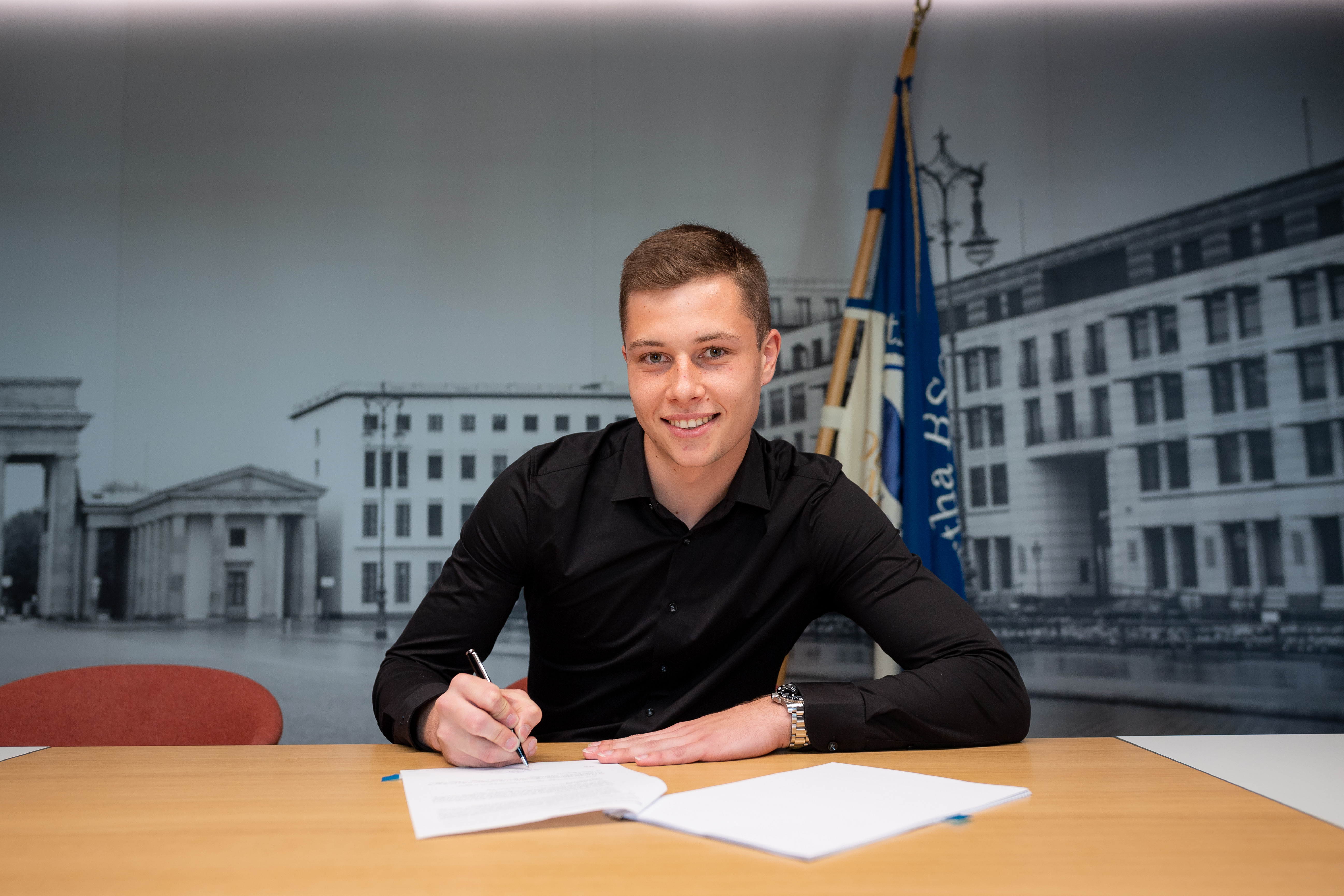 Tjark Ernst signing his contract.