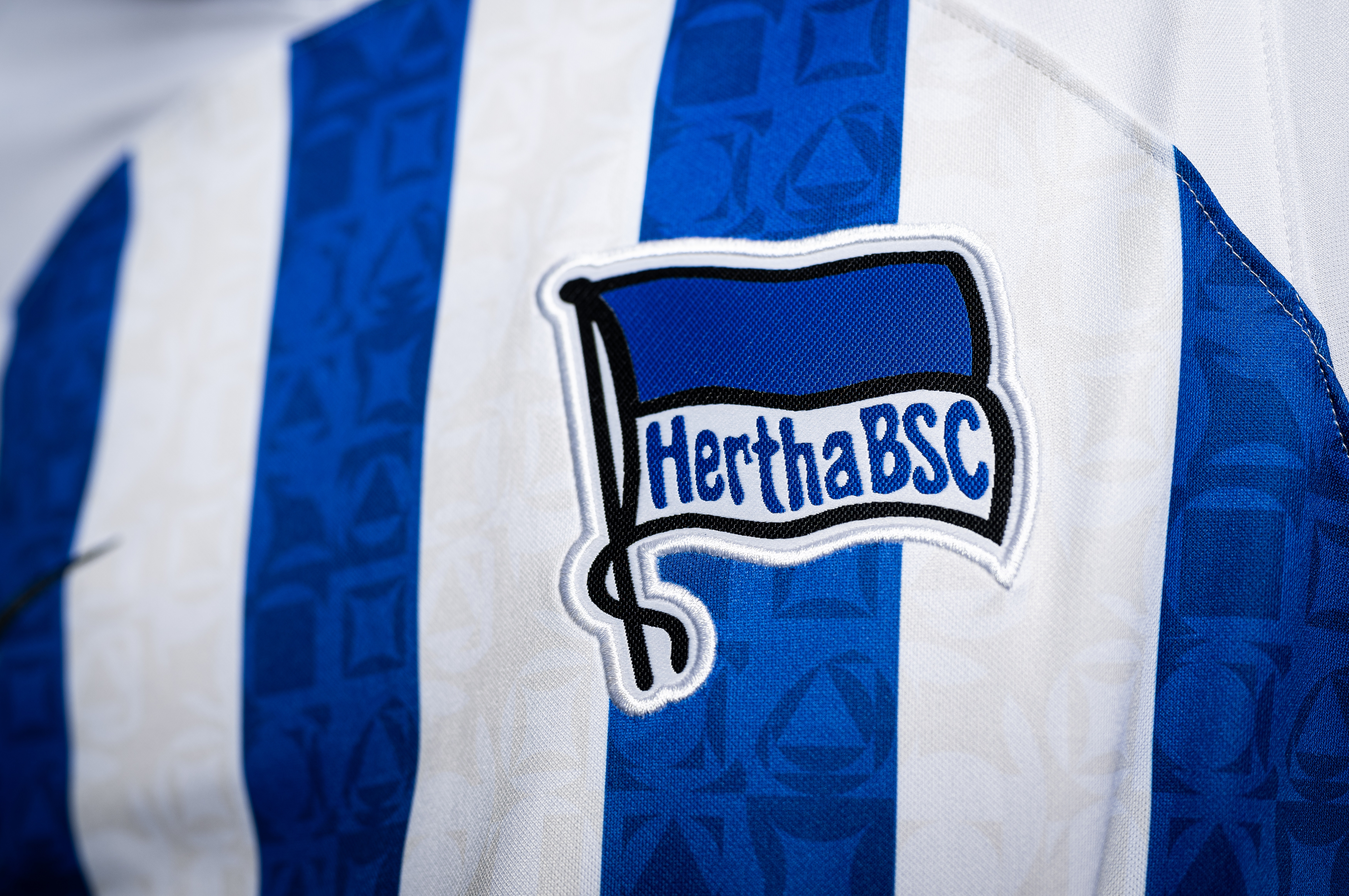 The Hertha logo on the home shirt.