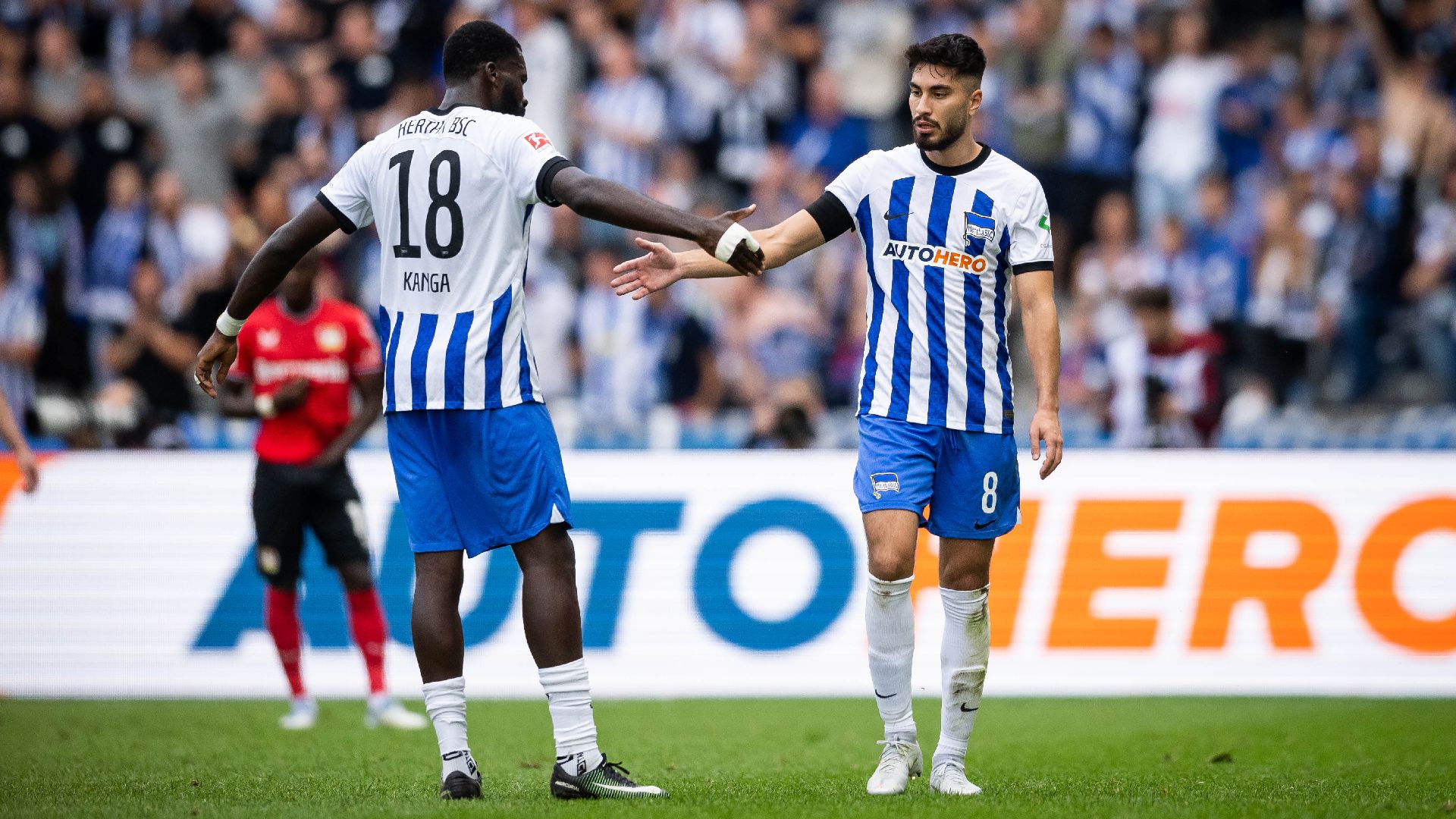 Wilfried Kanga and Suat Serdar high five.