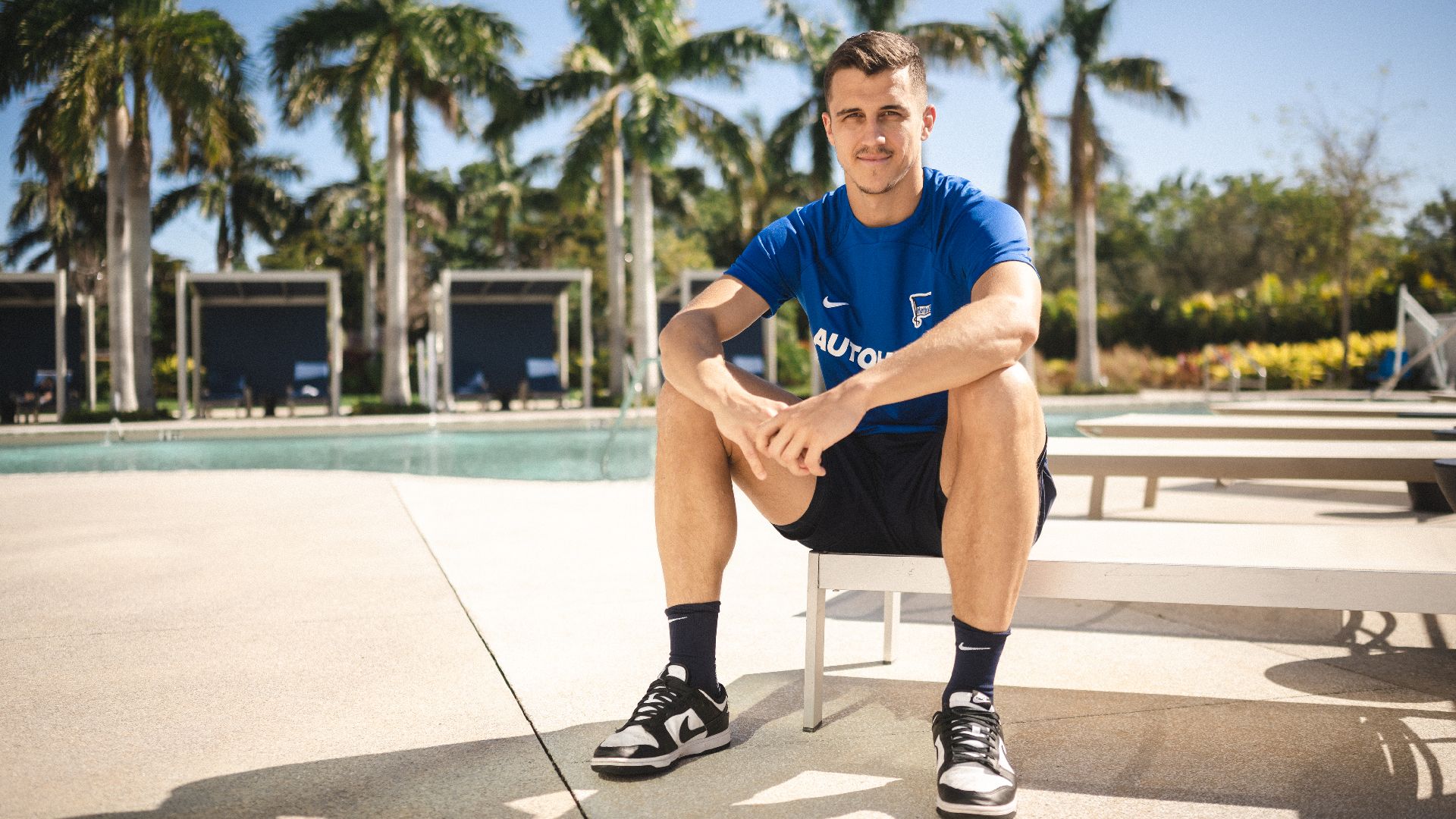 Marc Kempf sitting by the pool.