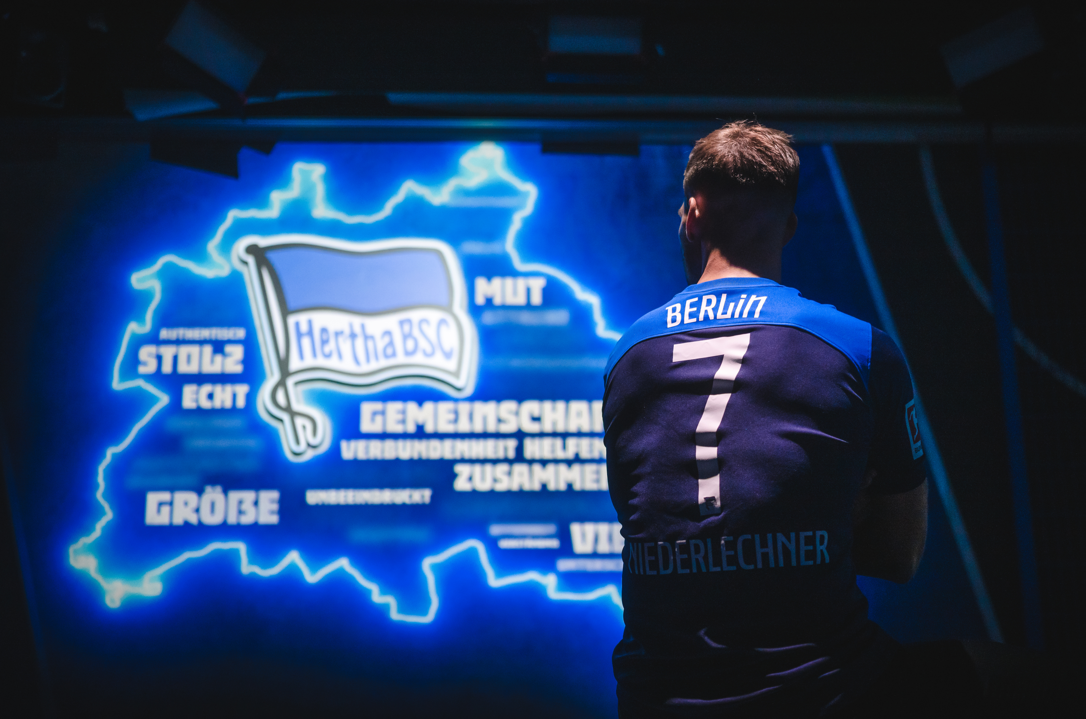 Florian Niederlechner wears the away jersey with his name on the back.