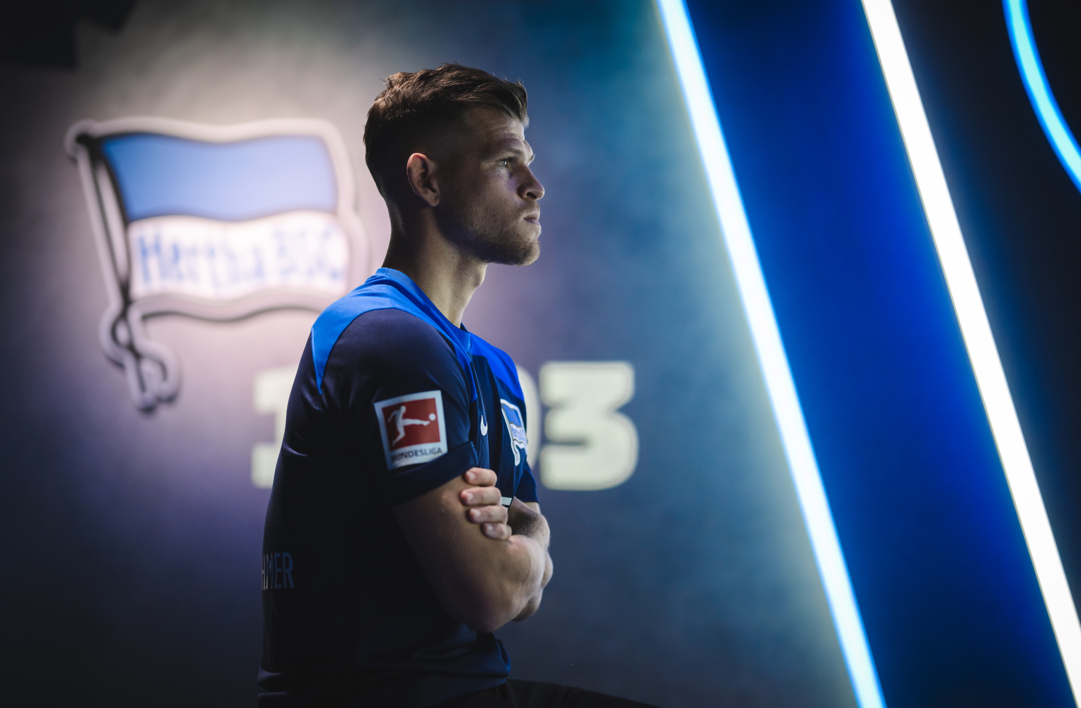 Florian Niederlechner wears the away shirt with his right shoulder to the camera.