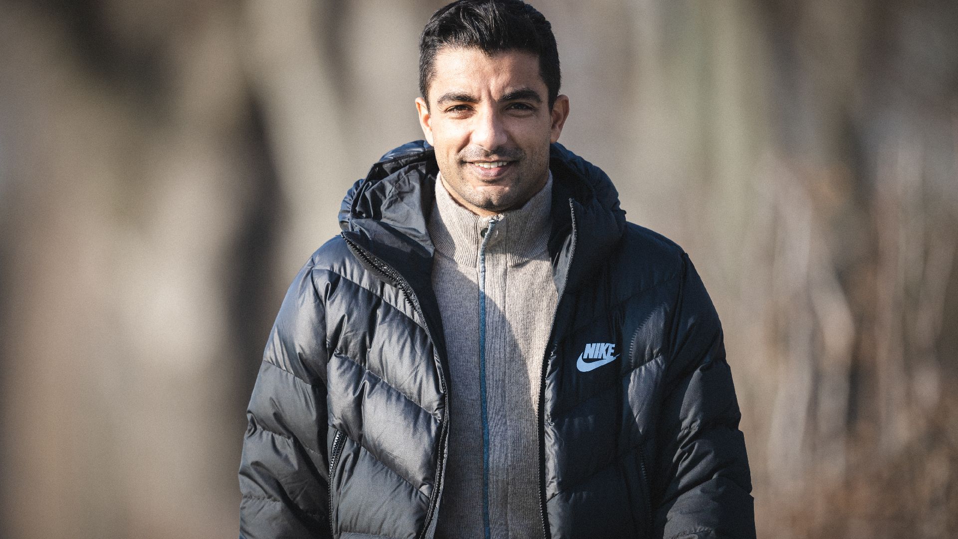 Sami Allagui walking smiling at Schenckendorffplatz.