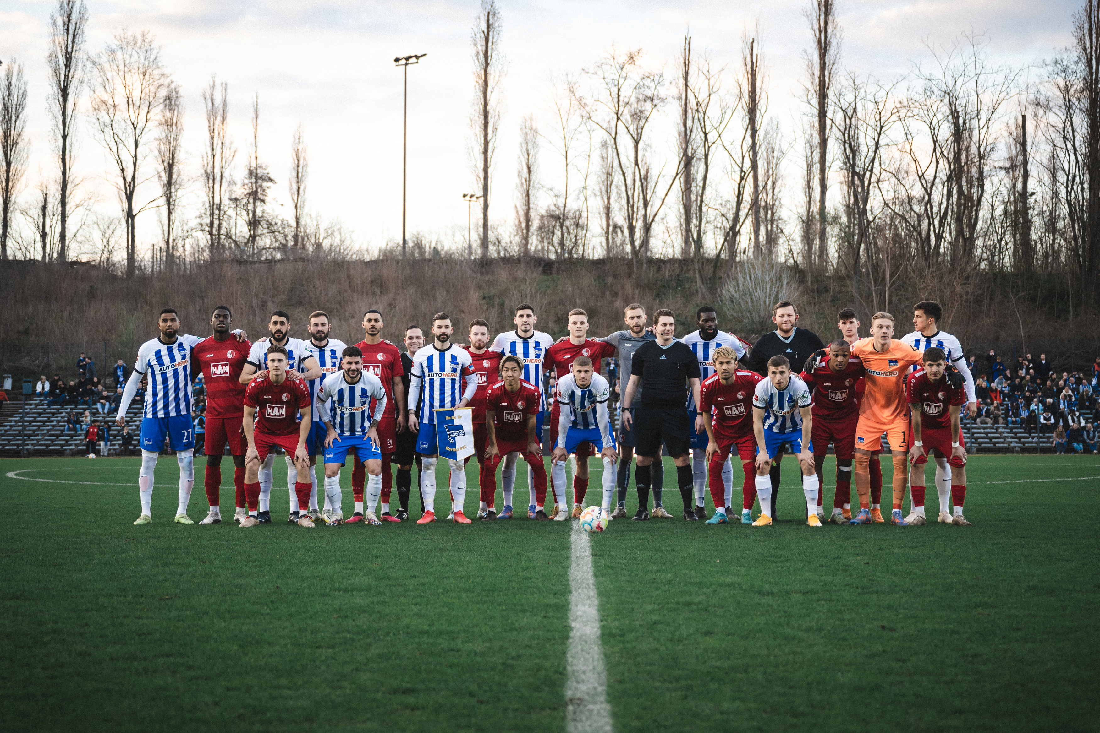 Berliner AK and Hertha BSC pose for a group photo before the game.