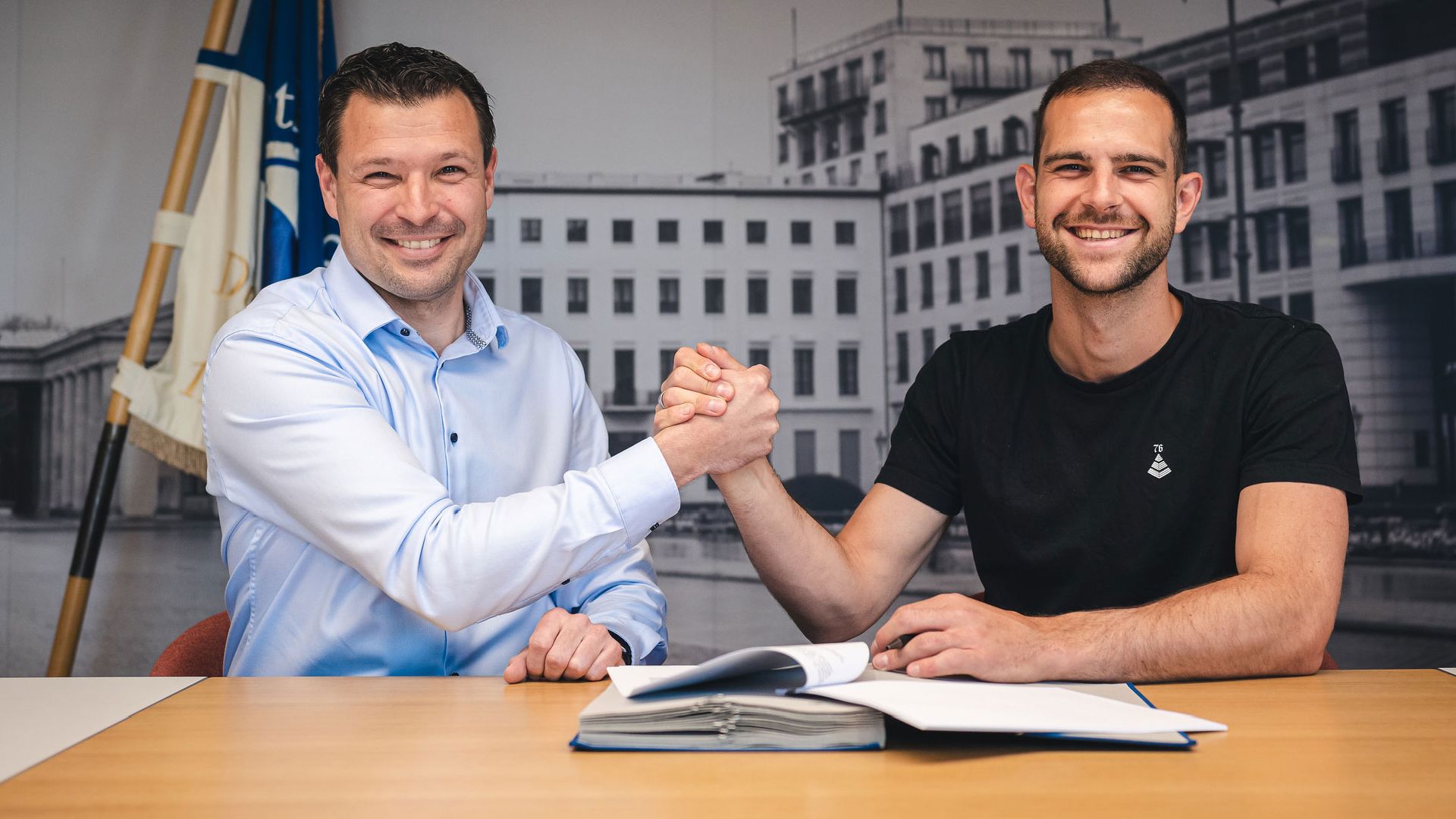 Benjamin Weber and Marius Gersbeck shake hands as the goalkeeper signs a contract with the club.