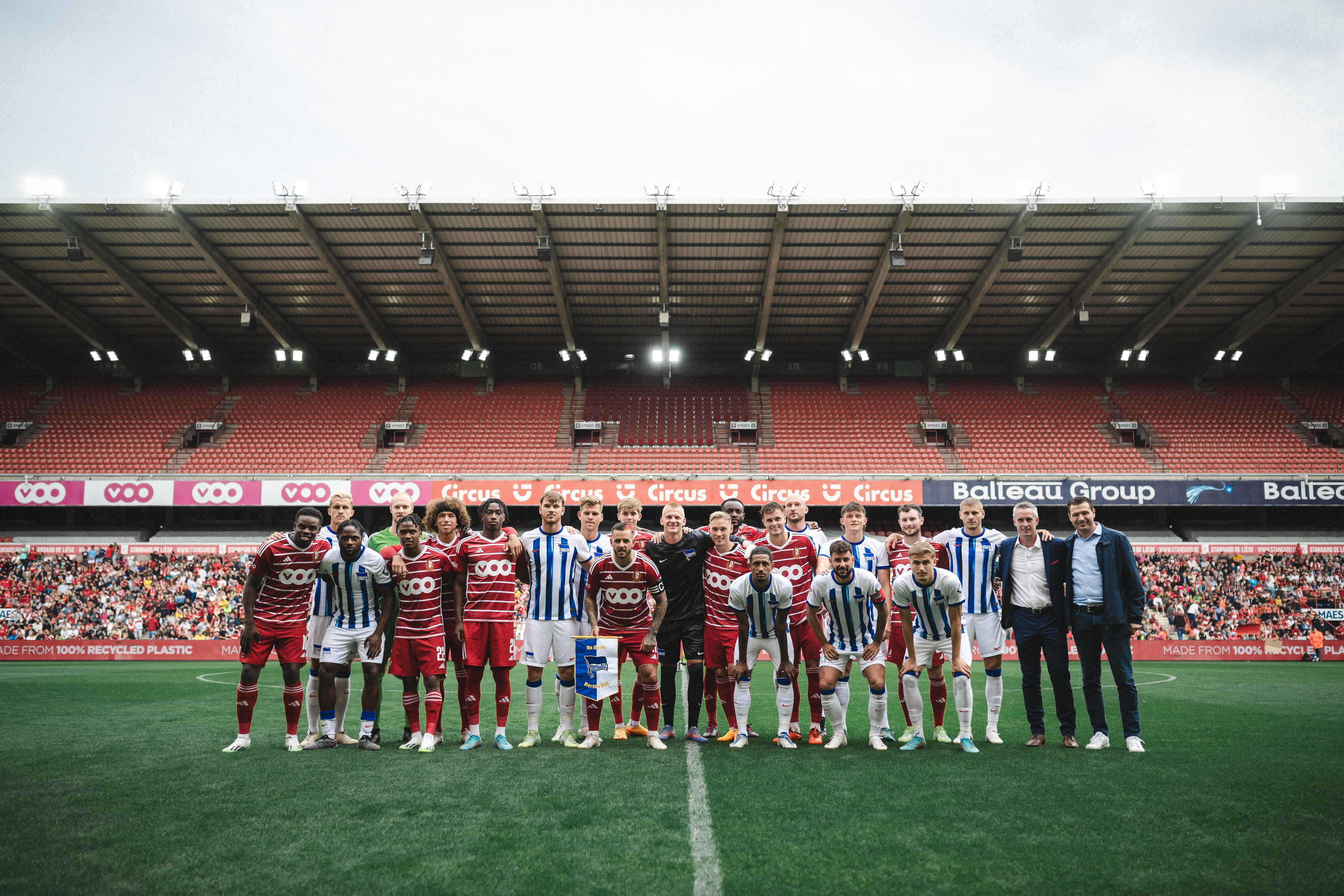 Standard and Hertha players pose for a picture together.