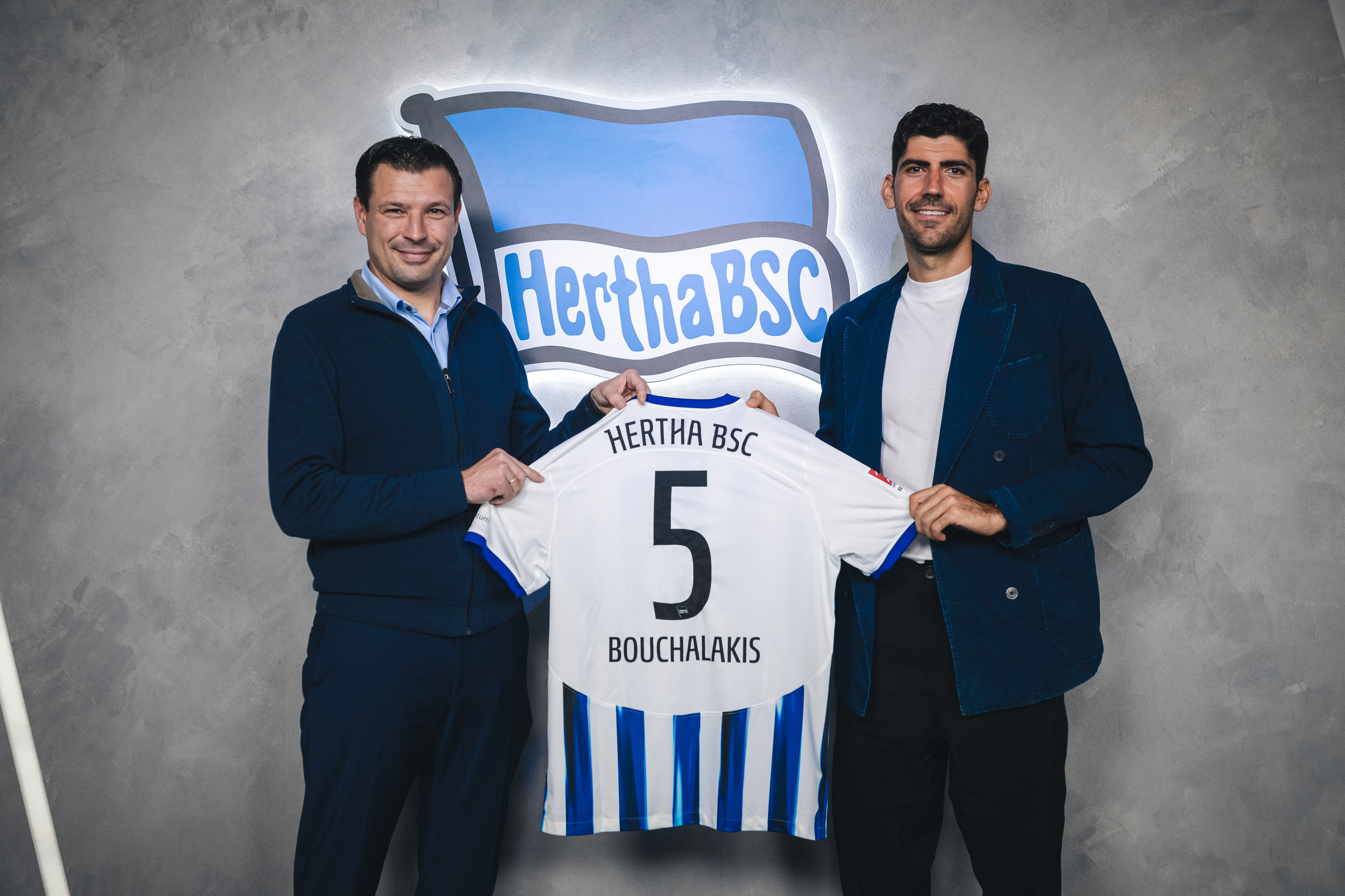 Benjamin Weber and Andreas Bouchalakis hold up the midfielder's number 5 shirt