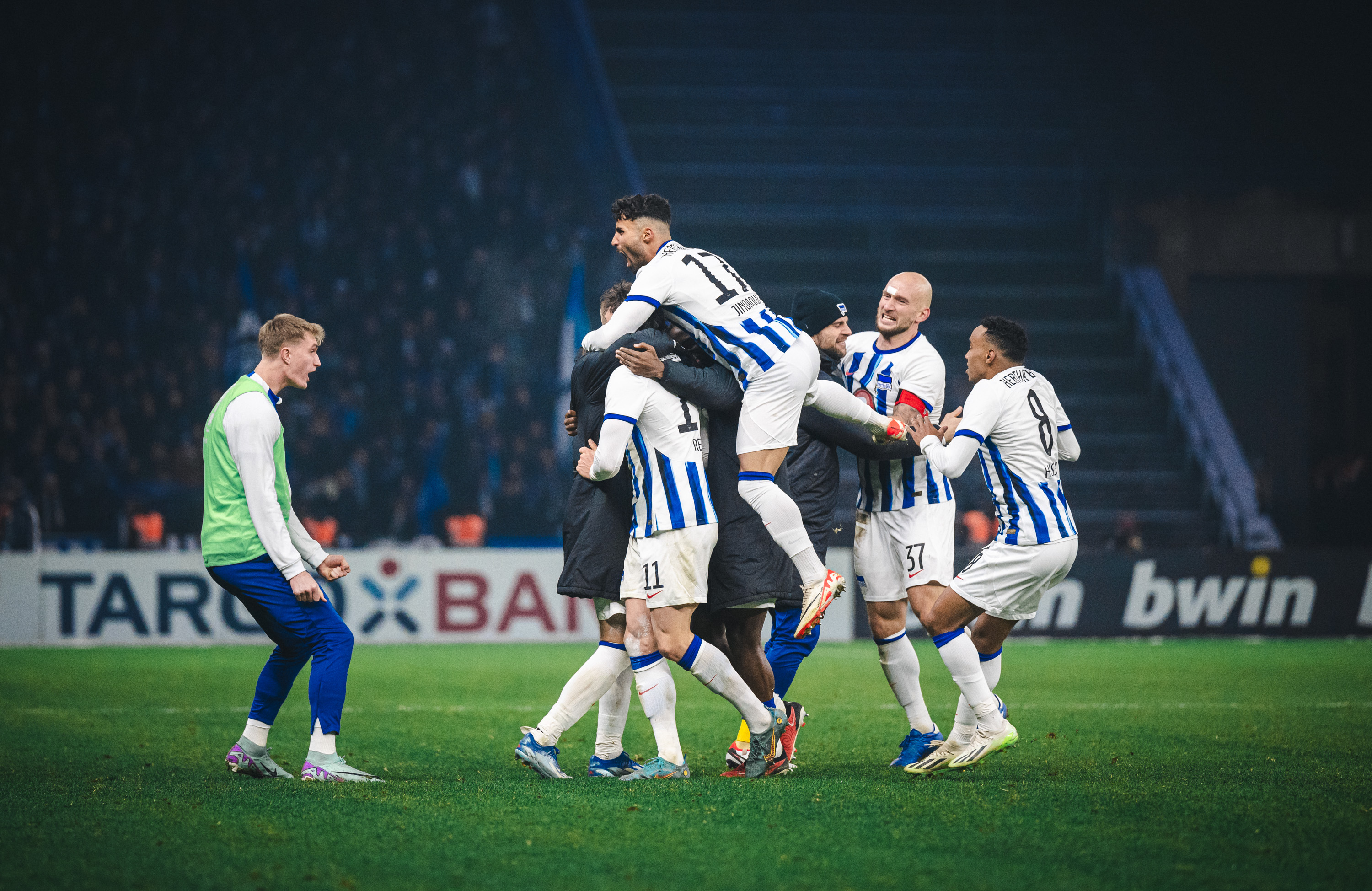 The Hertha players celebrate the 90th-minute equaliser.
