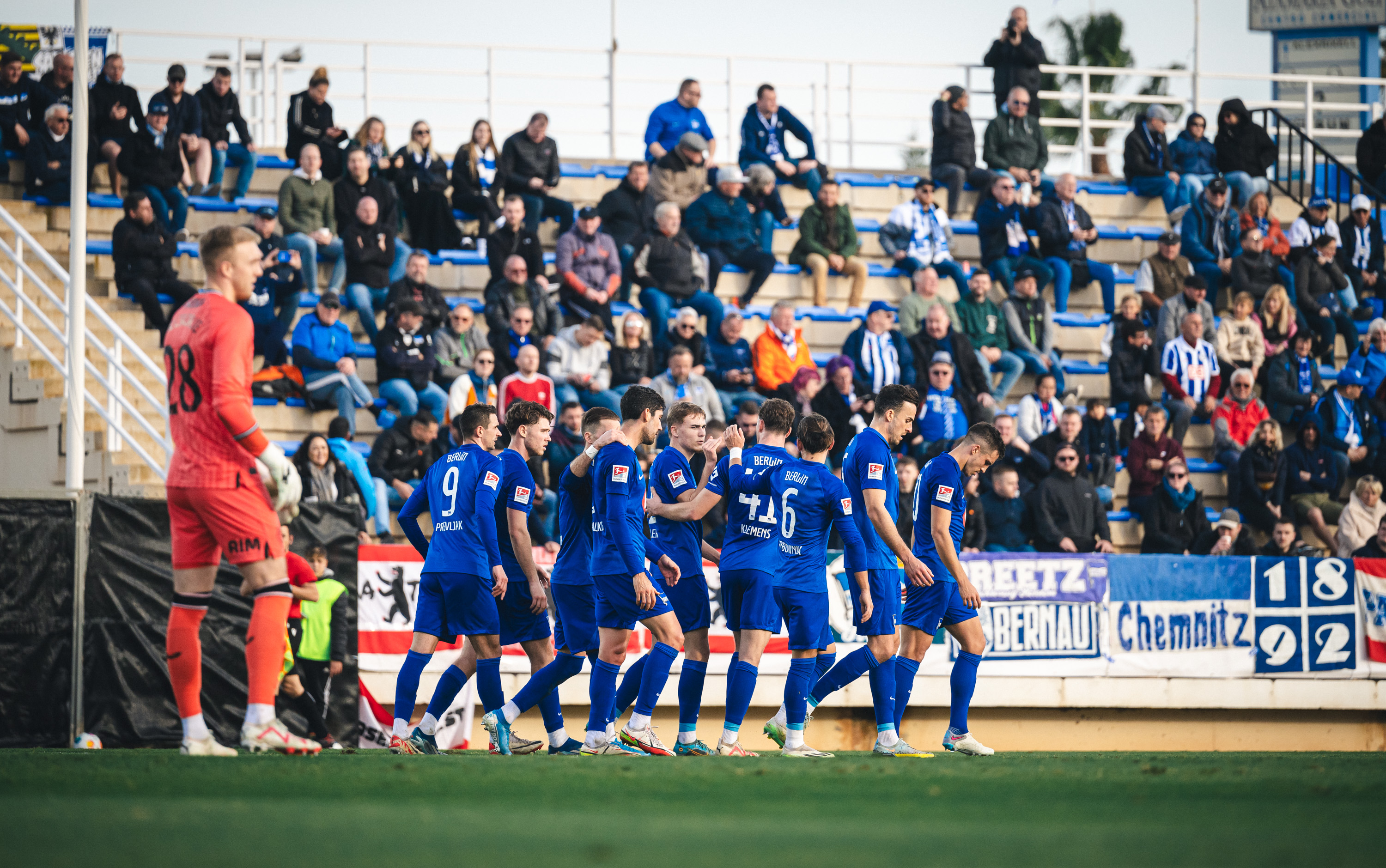 The players celebrate Kempf's goal.