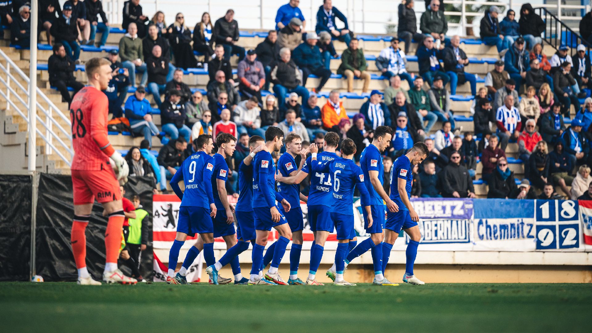 The players celebrate Kempf's goal.