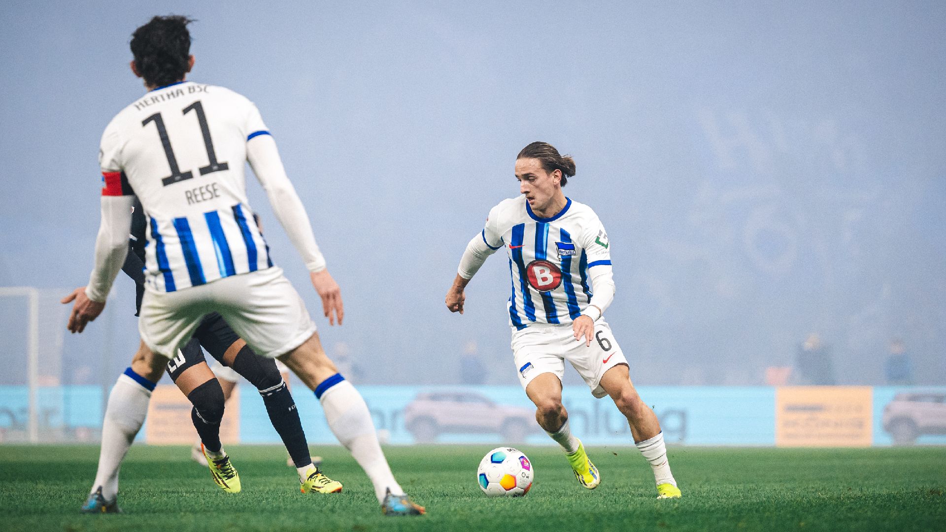 Michał Karbownik setzt zum Dribbling an, Fabian Reese beobachtet die Szene.