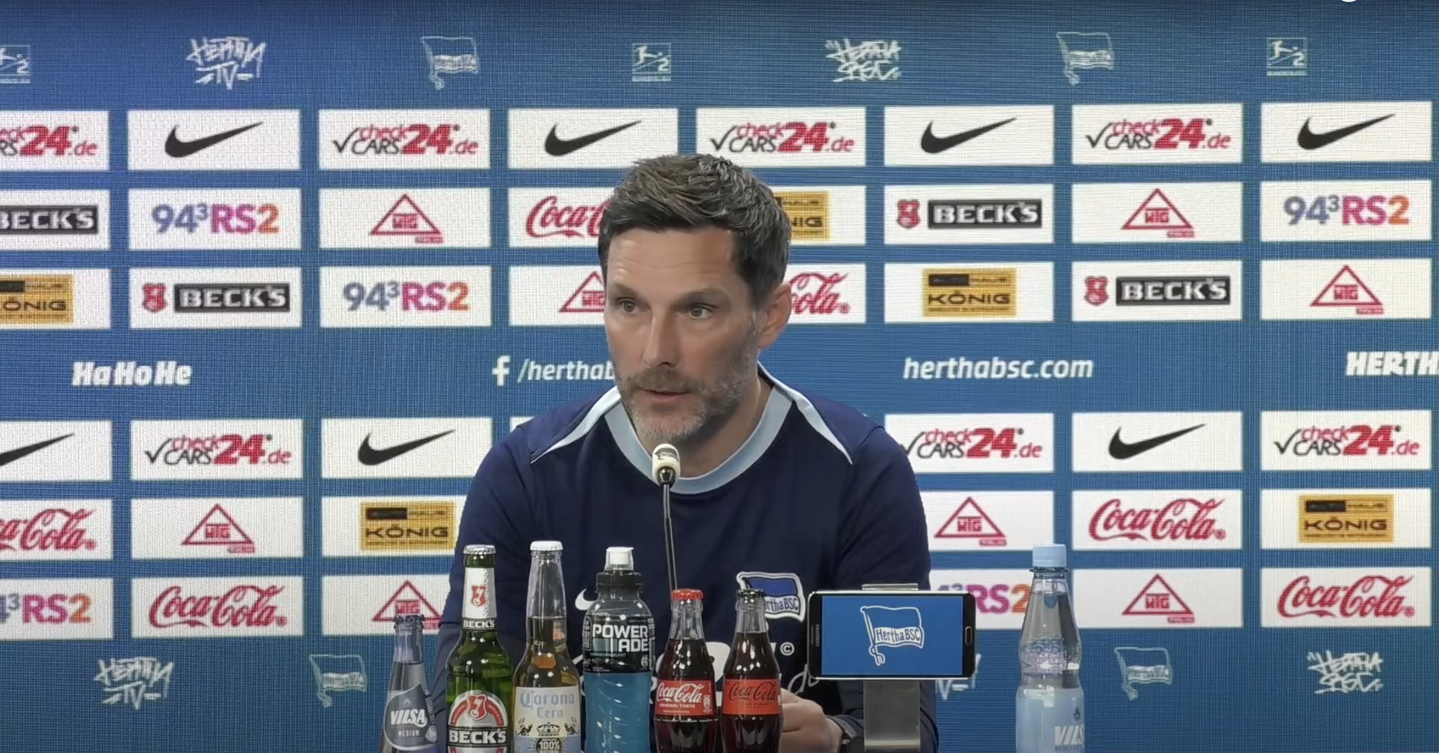 Stefan Leitl sitzt auf dem Podium bei der Pressekonferenz.