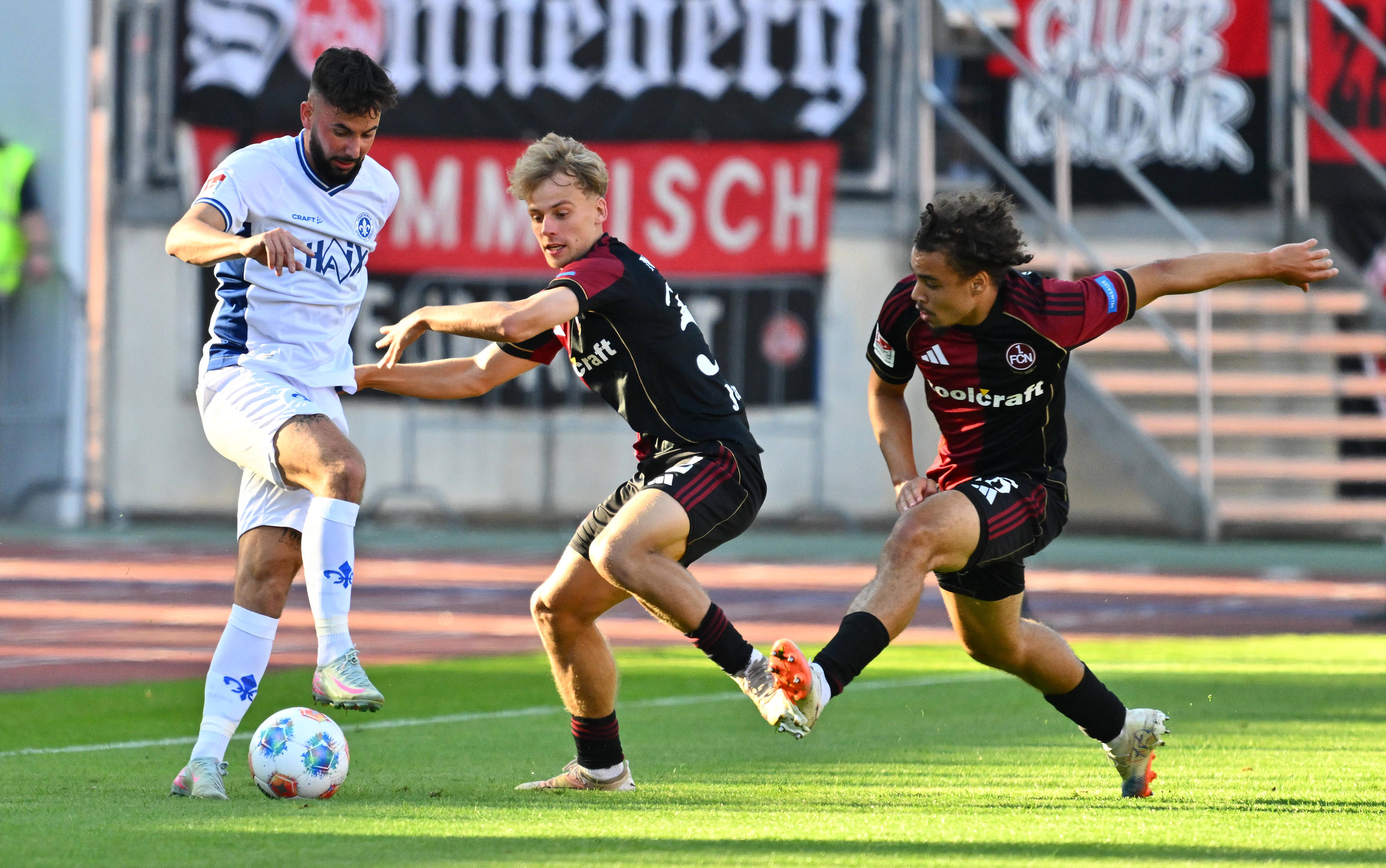 Marco Richter im Zweikampf mit zwei Gegenspielern.