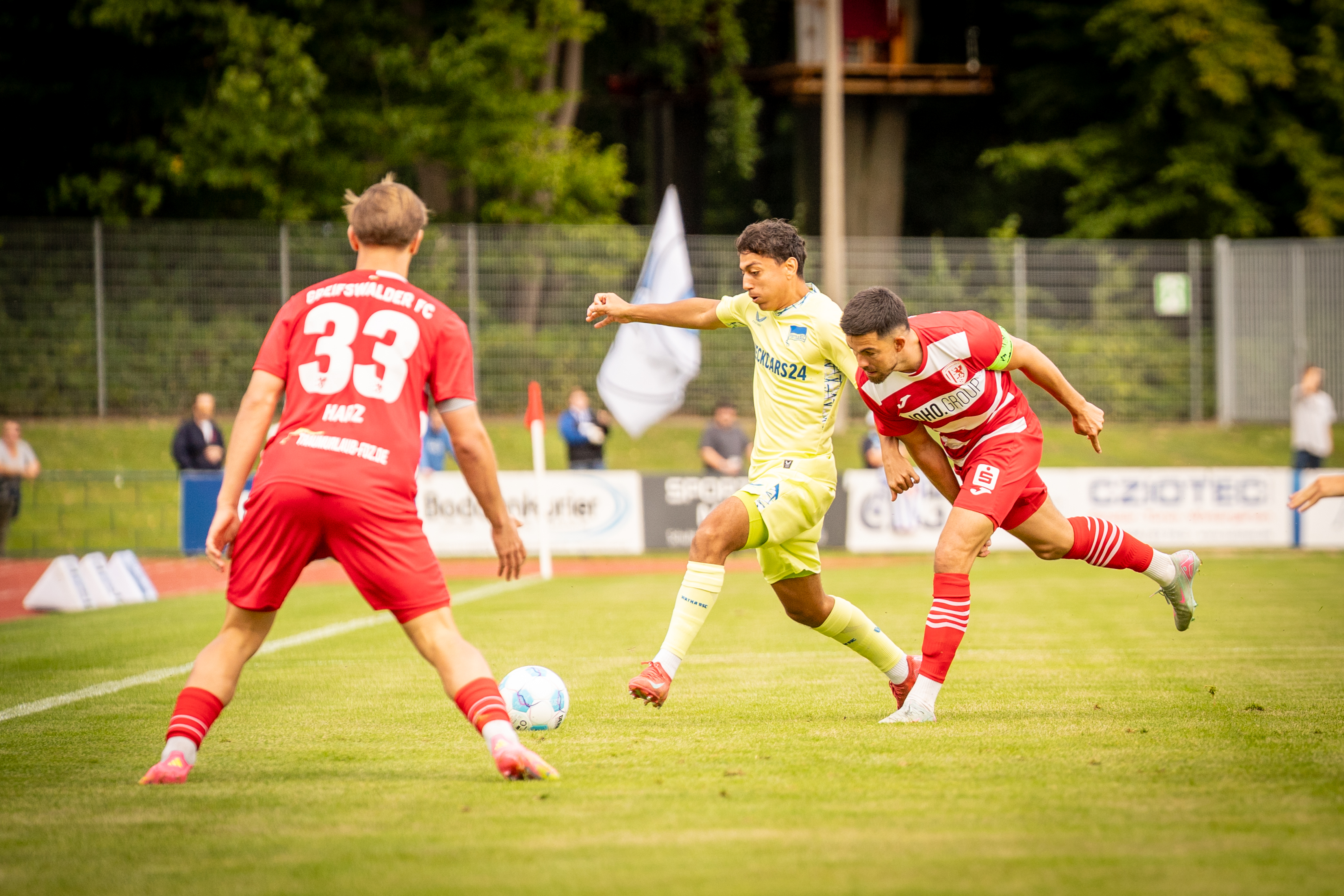 Eliyas Strasner im Zweikampf mit zwei Greifswalder Gegenspielern.