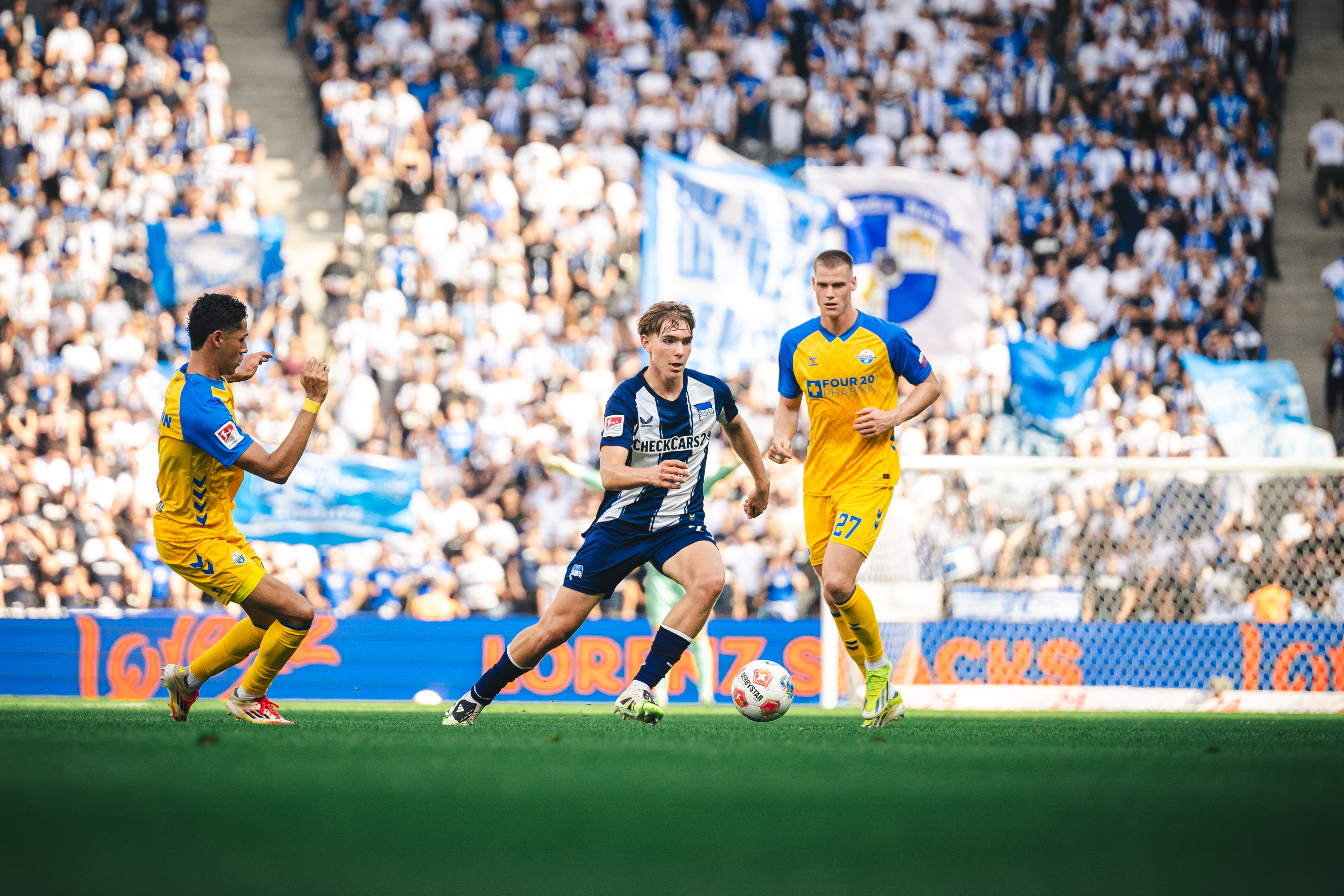 Kennet Eichhorn mit Ball am Fuß gegen zwei Spieler des SC Paderborn.