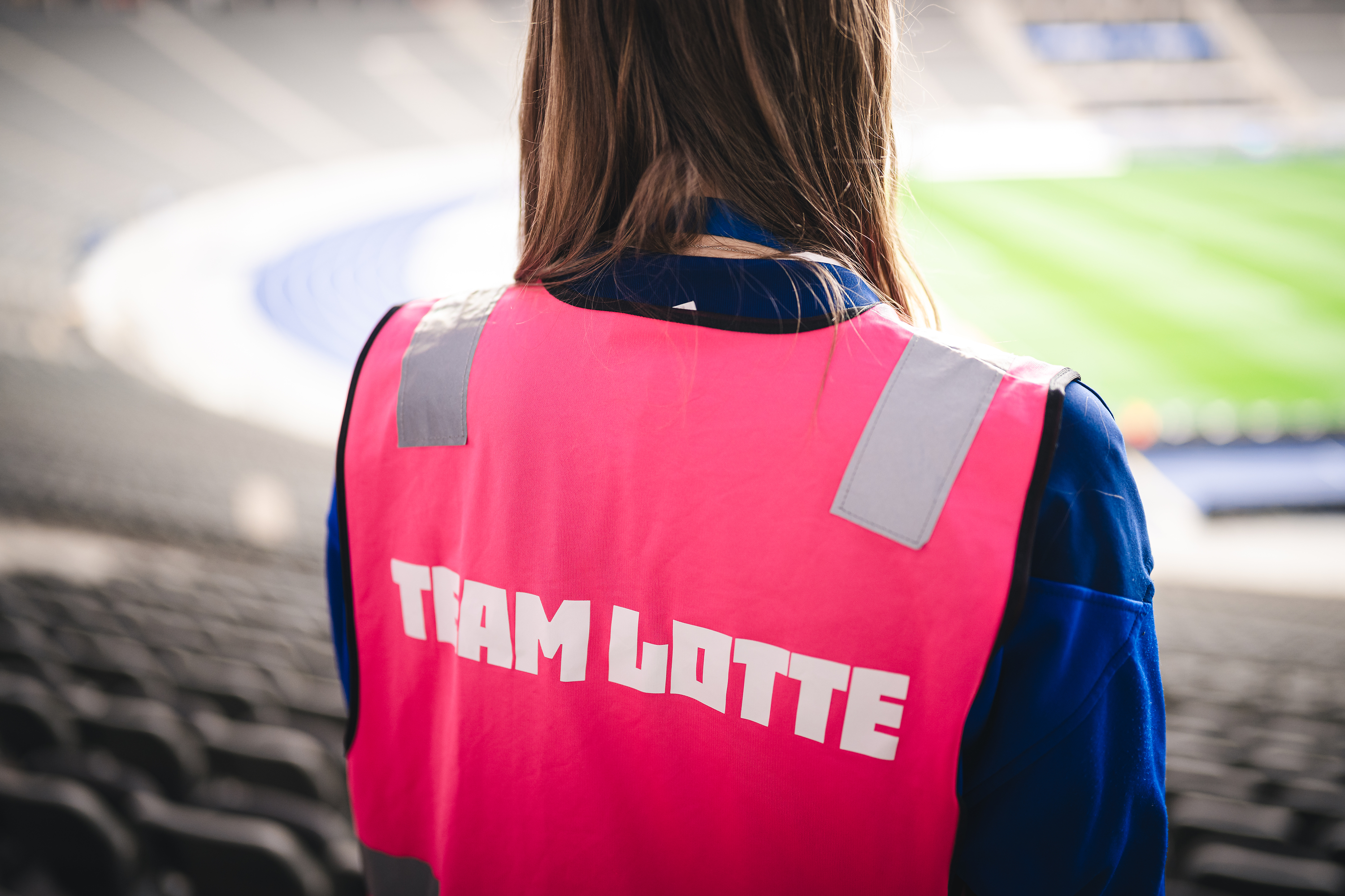 A person with a Lotte-vest on the stands.