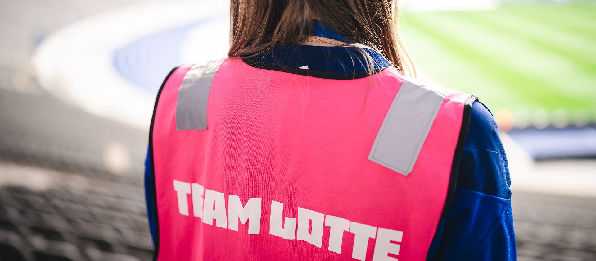 A person with a Lotte-vest on the stands.