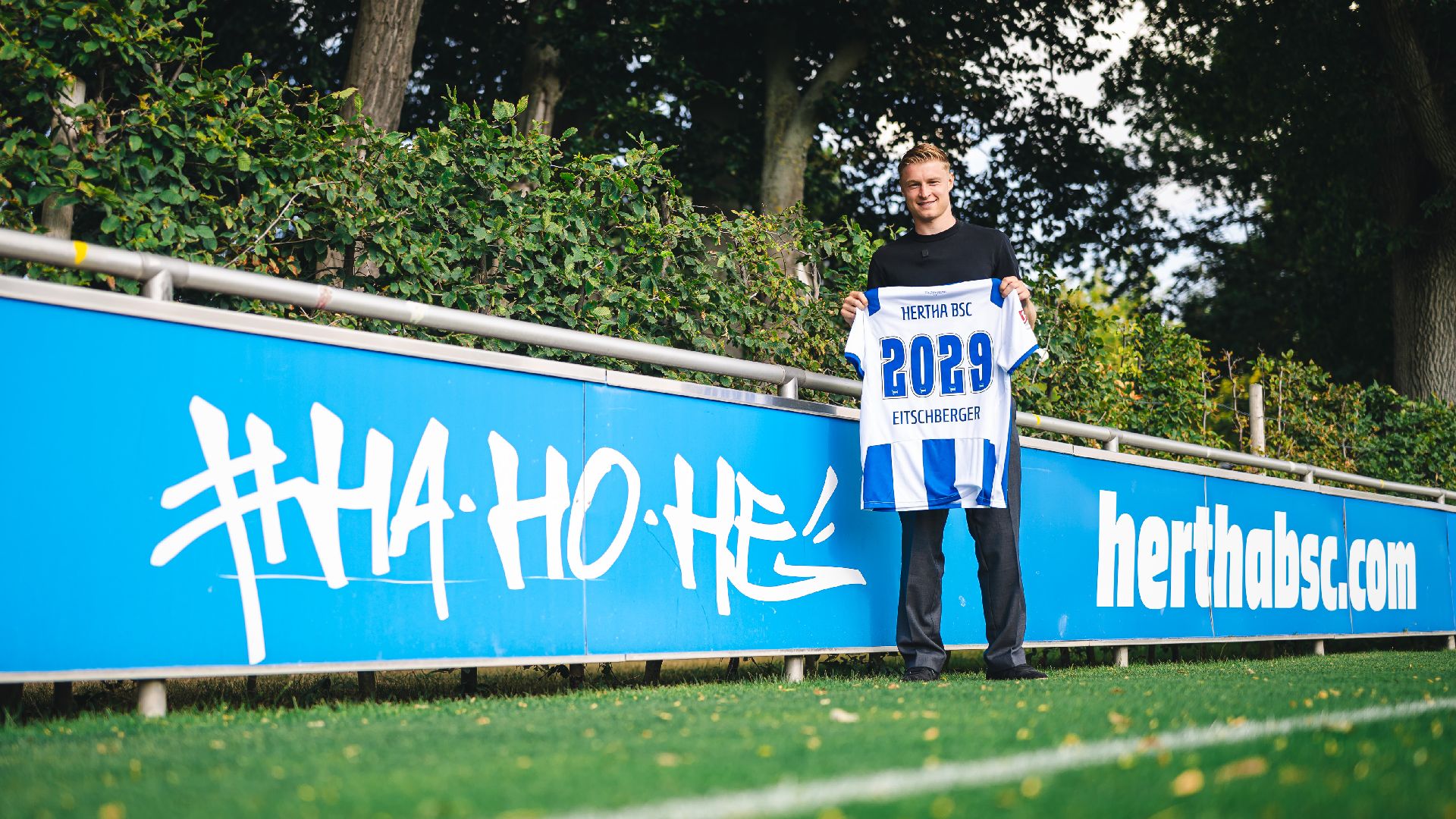 Julian Eitschberger hält ein Hertha-Trikot in die Höhe.